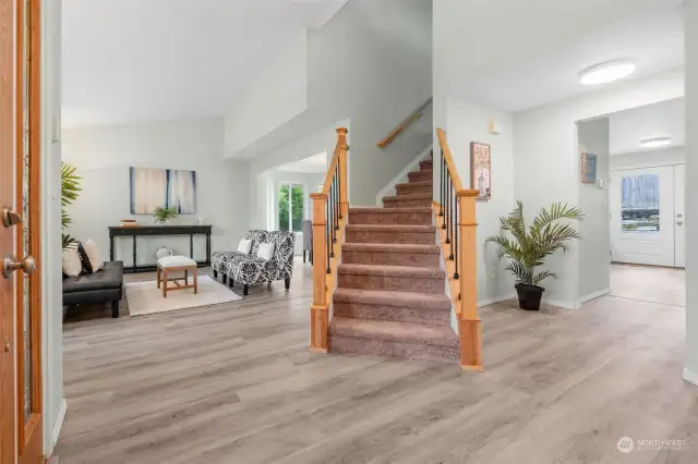 Welcome Home!  An amazing main floorplan where the staircase is centerstage and all the living and dining areas flow around it.