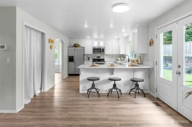 This kitchen!  Light, bright and so spacious! Lots of counterspace and room for several cooks all at the same time! Extra large pantry with deep shelving on the left.