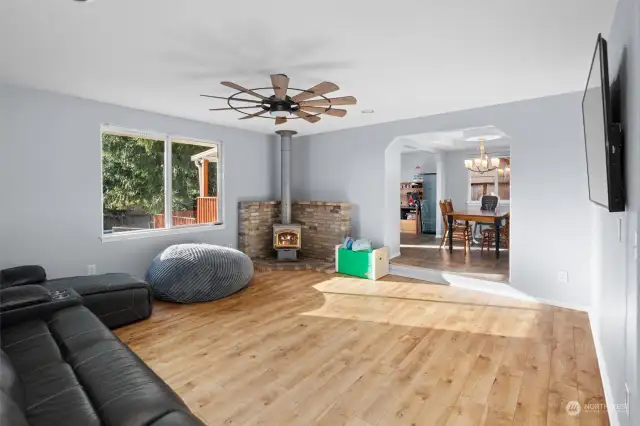 Cozy living room with wood burning stove and upgraded living room ceiling fan.