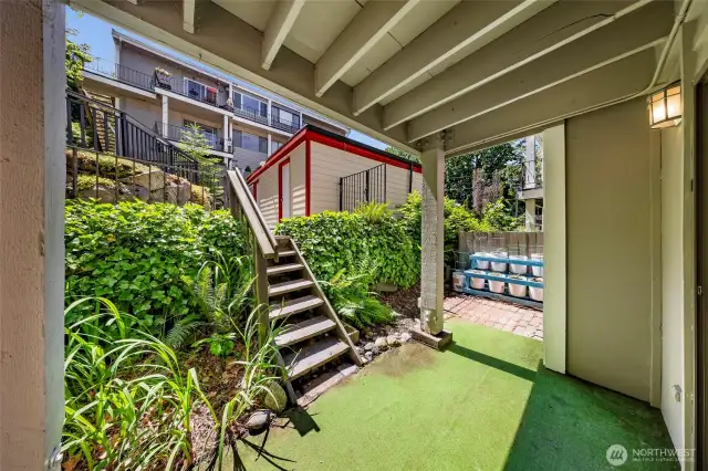 Your private oasis! There is room to garden (vegetables are growing in the white containers). With plenty of space for a table and chairs you can enjoy dining outside.