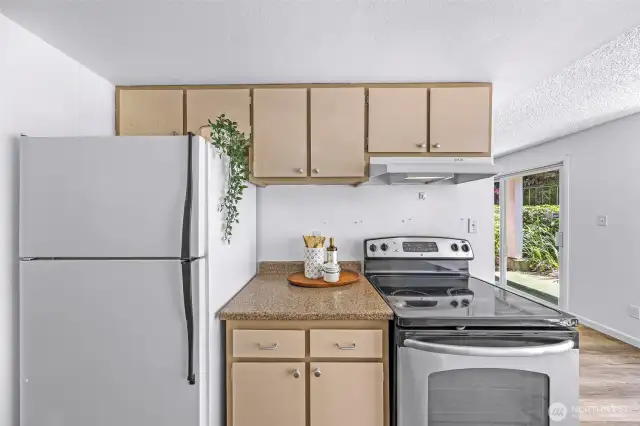 The kitchen is equipped with a pantry, new sink, electric stove/oven and plenty of storage space.