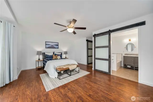 Barn doors lead to primary bath