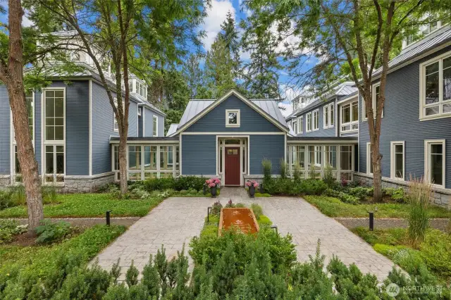 Front exterior of home with water feature and professional landscaping