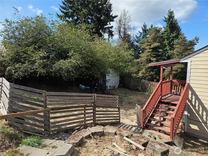 Fully fenced yard with storage shed in back corner