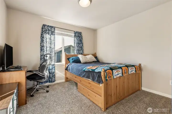 Still spacious but the smaller of the secondary bedrooms upstairs.