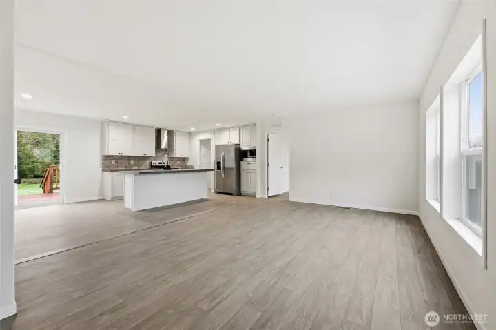 Open concept main living space and kitchen with eat in bar. Kitchen has a ton of storage.