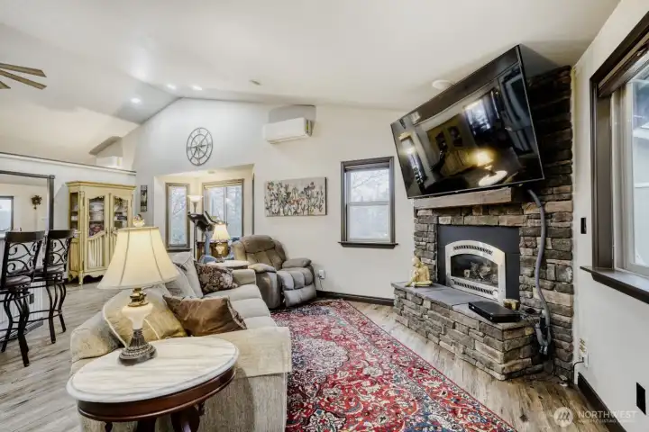 This cozy living room is open to the kitchen and overlooks the backyard and deck. Gas fireplace, vaulted ceiling, light and bright! New flooring througout this gorgeous home.