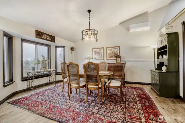 Dining room with bay windows, vaulted ceiling and mini split. Plenty of room for entertaining!