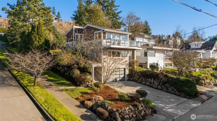 Home sits up high on a quiet corner lot offering privacy and views.