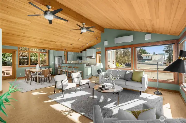 The open floor plan seamlessly unites the living, dining, and kitchen spaces, creating an inviting setting for gathering.