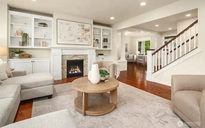 Family room with built ins framing the fireplace (fire added for visual effect, buyer to verify functionality).