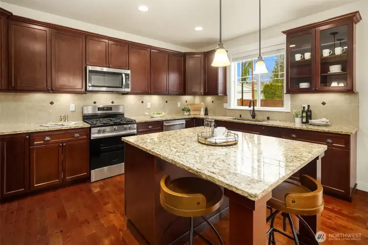 Oversized kitchen island with barstool seating and ample cabinet storage.