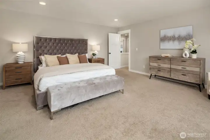 Spacious primary bedroom on second floor with ensuite bath and private balcony.