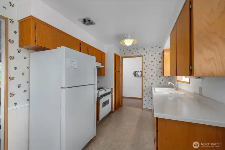 Prep meals comfortably in this kitchen with abundant cabinets and easy flow.
