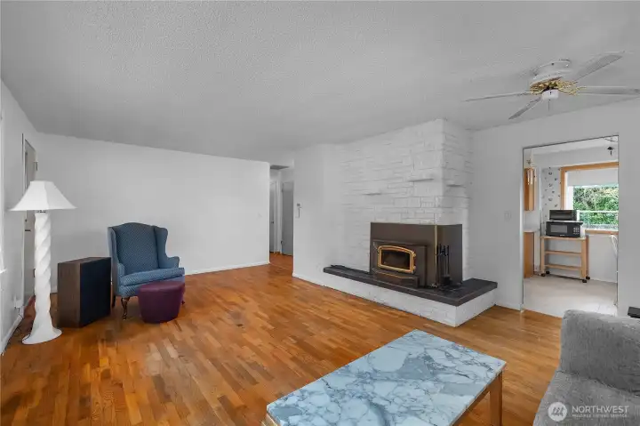 Gather around the fireplace in this spacious living room filled with warmth and character.