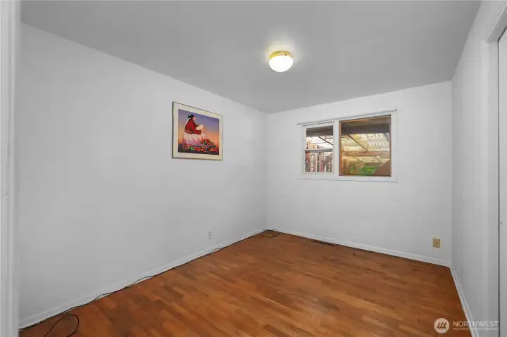BR 1 - Create a comfortable retreat in this bright bedroom with hardwood flooring.