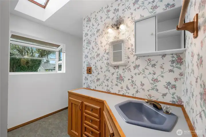 Main Level Full Bath -Refresh in this bright full bath enhanced by a skylight overhead.