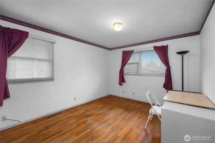 BR 3 - Spacious bedroom with hardwood floors and large windows for a bright, open feel.