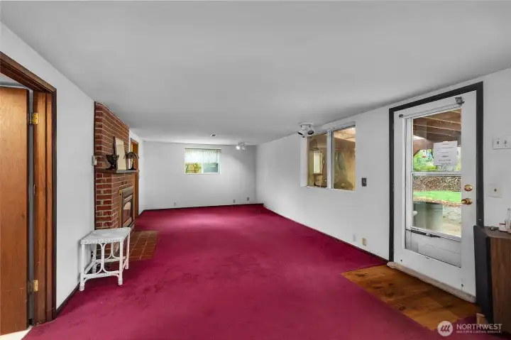 Spread out and entertain in this large lower-level family room with fireplace and outdoor entry.