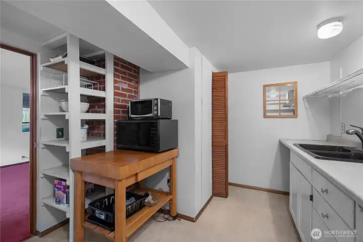 Expand your living options with this practical lower-level kitchenette setup.