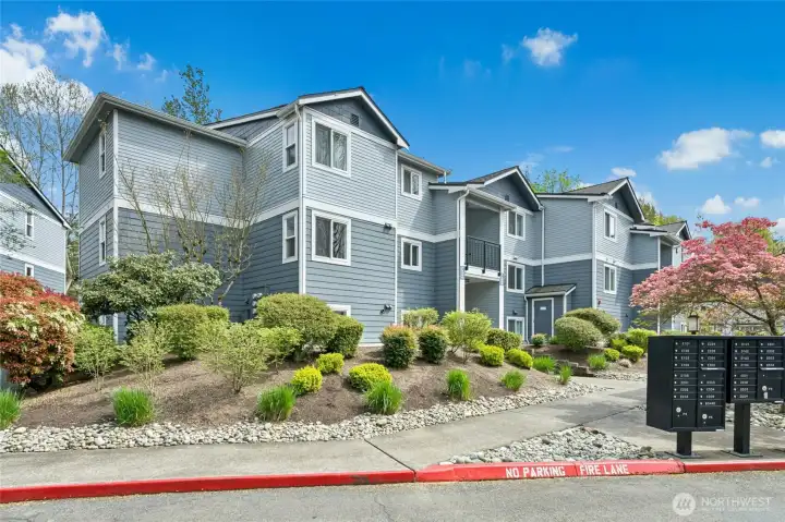 Exterior view of well-maintained condo community with landscaped grounds and inviting curb appeal.