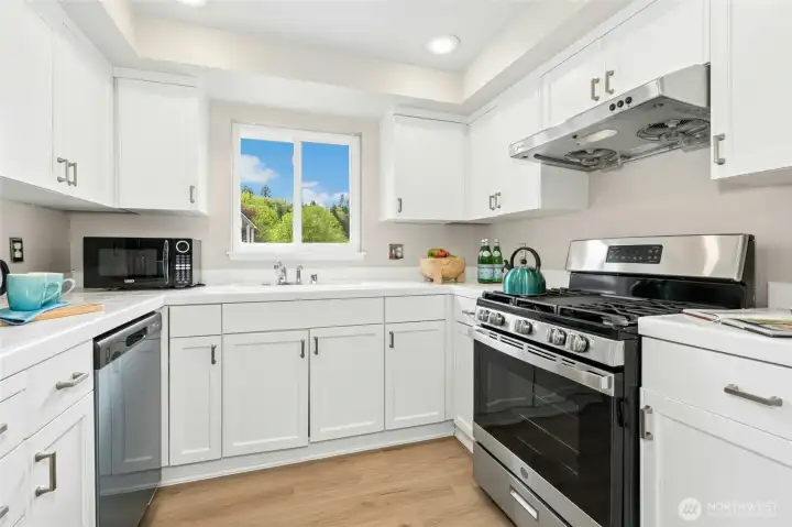 Kitchen with ample cabinetry, counter space, and modern appliances.