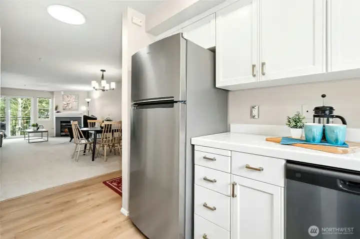 Kitchen view with stainless appliances and open sightlines to dining.