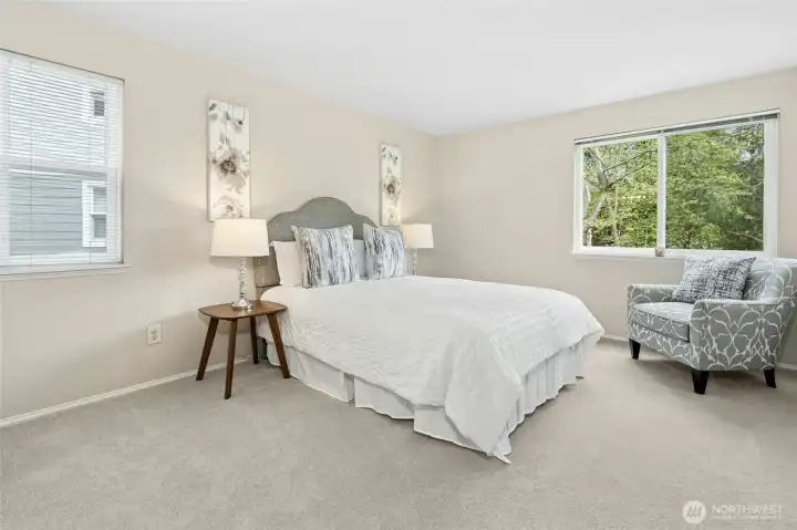 Primary bedroom with large windows and comfortable layout.