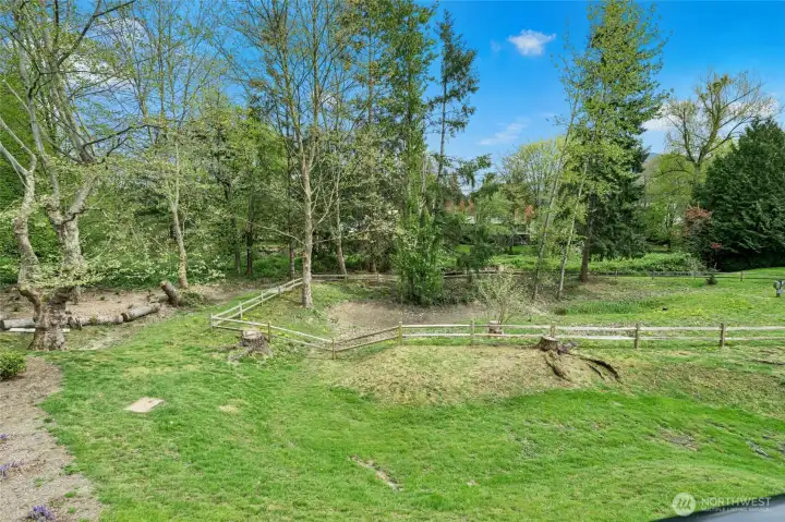 Community green space with lawn and mature trees.