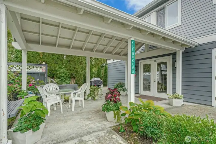 Community clubhouse exterior with covered gathering area.