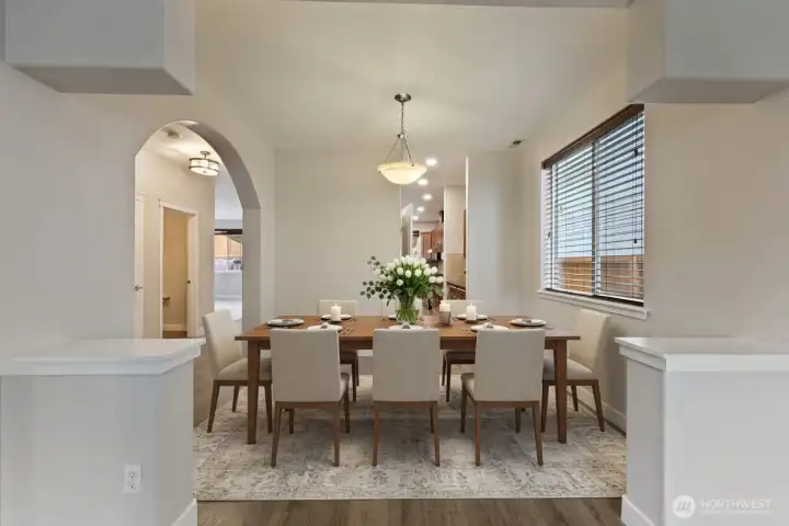 Beautiful dining area framed by architectural archways and filled with natural light. The open yet defined layout creates an inviting atmosphere, perfect for both everyday living and entertaining. Conveniently located near the butler’s pantry and adjacent flex room, this elegant space features arched entryways, and neutral finishes that create a timeless setting for family dinners and special occasions.