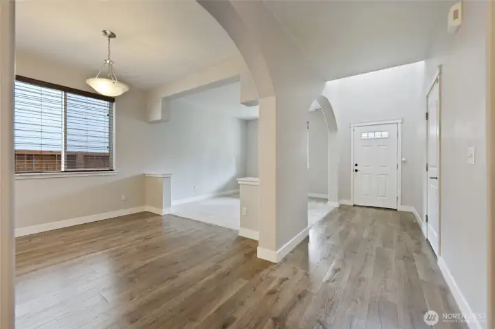 A stunning dining space framed by timeless archways and bathed in natural light, offering an open yet defined setting that’s perfect for hosting, gathering, and creating memorable moments.