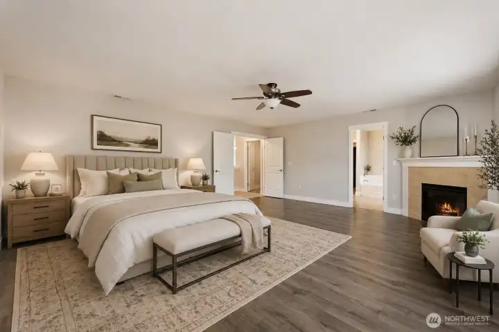 This expansive primary bedroom is a masterpiece of comfort and elegance — a grand, light-filled retreat that feels like a luxury resort. A striking fireplace with a classic white mantel creates a stunning focal point, perfect for cozy evenings. The room is anchored by an elegant ceiling fan with lighting, large planks laminate flooring, and soft neutral tones that promote peace and relaxation. Multiple windows and French doors flood the space with natural light while offering seamless flow.