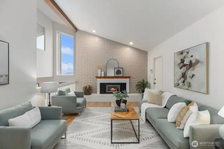 The great room to the right, garage access by fireplace