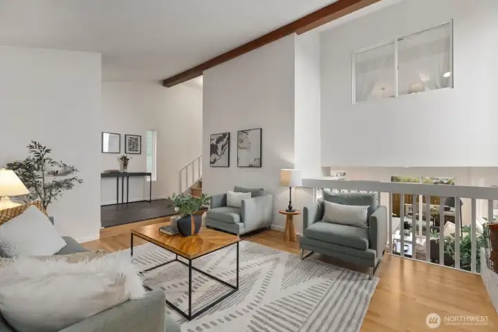The great room is open to the lower living room, kitchen, dining