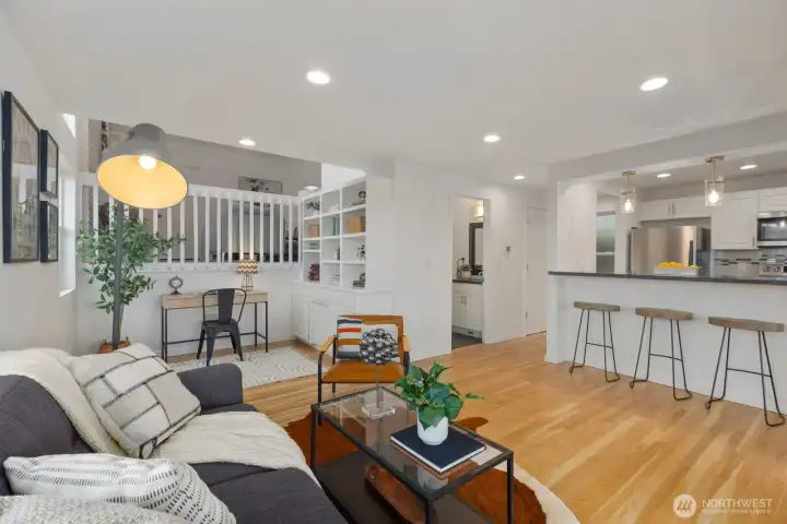 Downstairs, the living room, built-ins , kitchen, and half bath