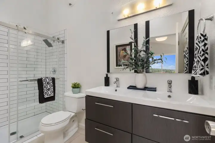 Primary suite with double sink and newly tiled shower