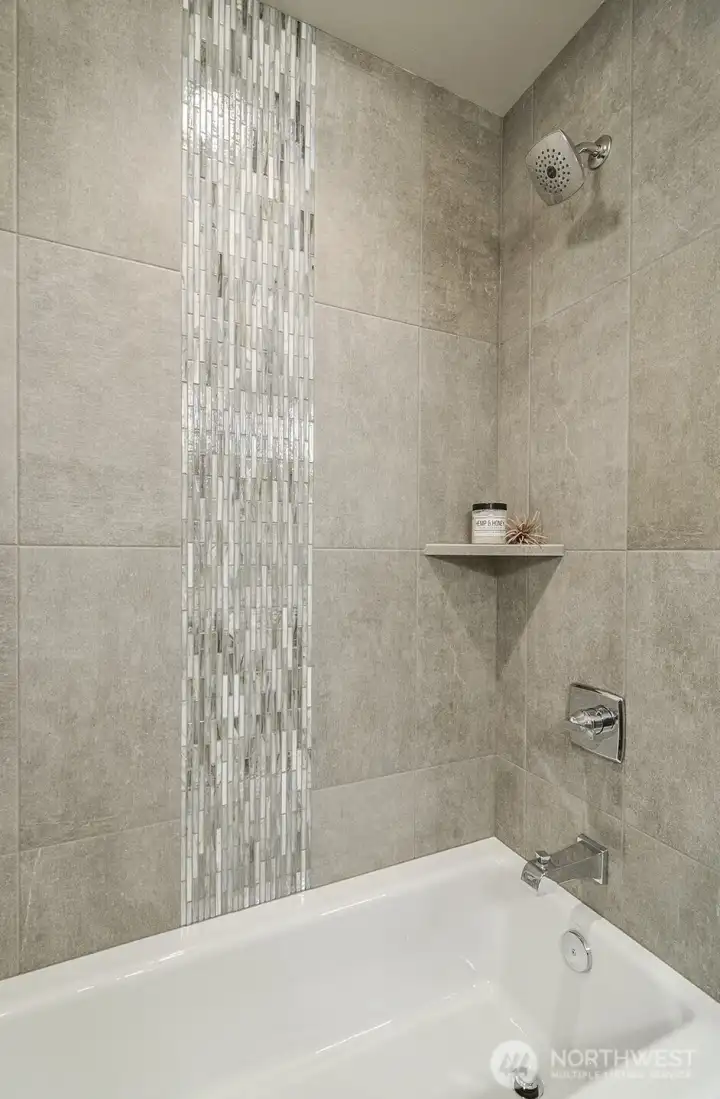 Tiled tub area in upper bath. Tiled tub area in upper bath.