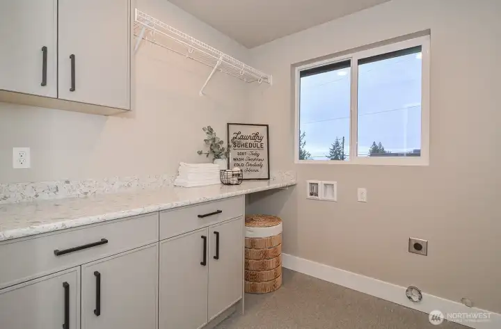 Upper level laundry room with cabinetry. Upper level laundry room with cabinetry.