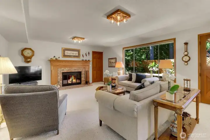 Family room with wood burning fireplace.