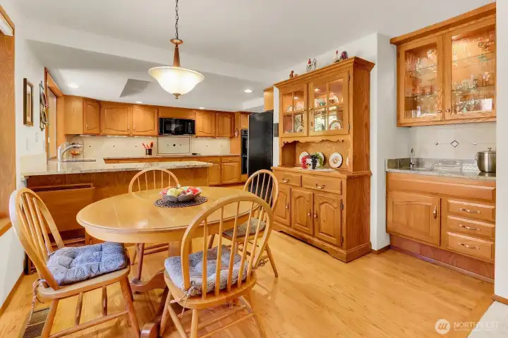 Kitchen with eating area and wet bar.