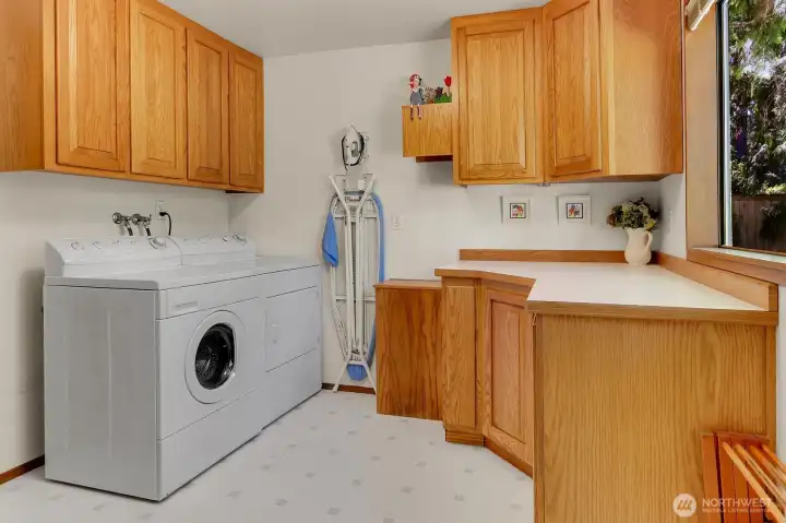 Main floor utility room with ample storage space.