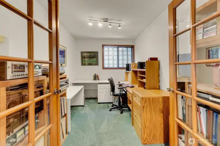 The primary suite has a den with french doors.