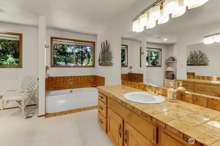 Primary bathroom with soaking tub and walk in closet.