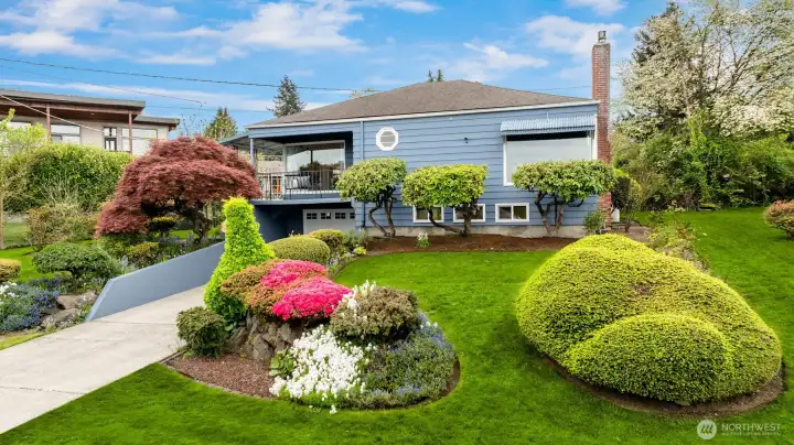 A magnificent mature maple anchors the lush, thoughtfully landscaped yard, where every season brings its own natural beauty and a sense of quiet Northwest tranquility.