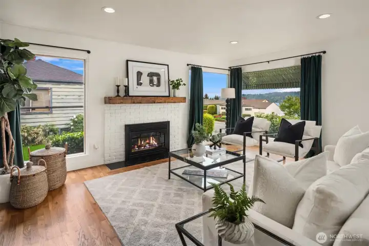 A light-filled, open-concept floor plan unfolds around a cozy gas fireplace, creating an inviting setting designed for effortless entertaining and everyday living.