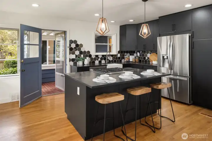 Centered around a spacious island with an integrated cooktop, the kitchen invites effortless conversation, shared meals, and memorable gatherings with family and friends.