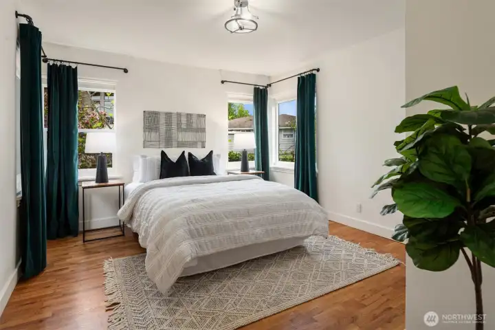 One of three spacious main-floor bedrooms, thoughtfully designed to provide comfort, flexibility, and abundant natural light.