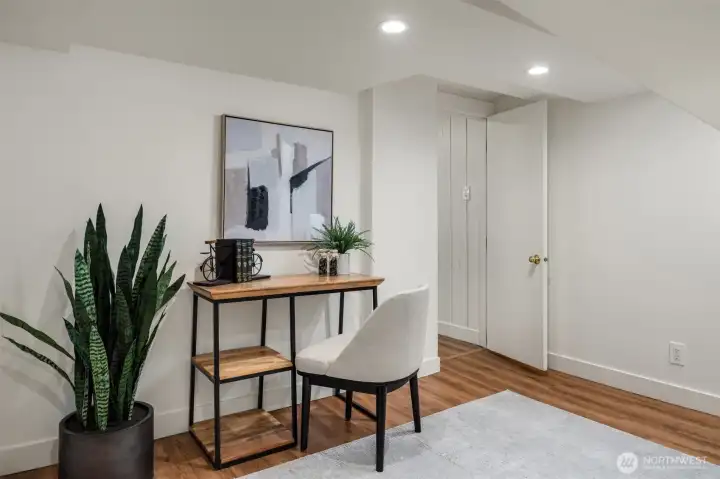 A versatile lower-level flex space offers the ideal setting for a private home office, creative studio, or quiet retreat.