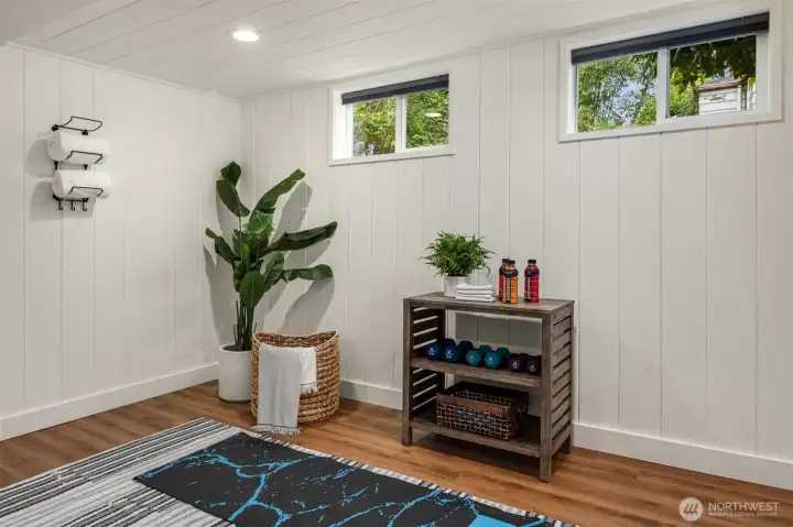 The spacious laundry room has ample space for a workout area, peloton or a treadmill.